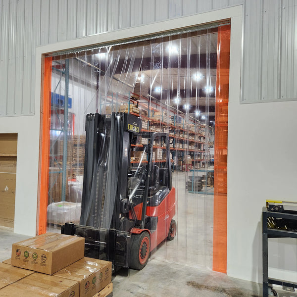 Forklift driving through a clear PVC strip curtain doorway
