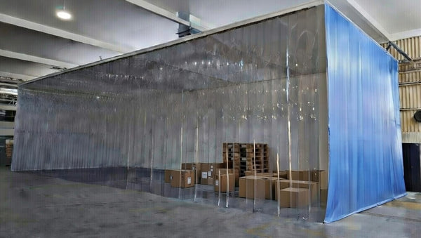 Large clear PVC strip curtain partition around a warehouse work area